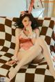 A woman in a bunny costume sitting on a couch.